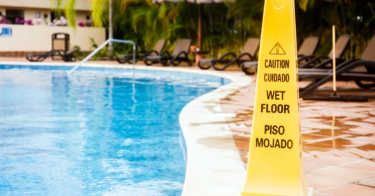 caution sign by pool